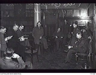 Melbourne, Vic. 1944-05-01. Lieutenant Colonel H. F. Cotton, Canadian Army, Leader of a party of ten Canadian Army officers giving a press conference in the Canadian Officers Mess. Lieutenant ..