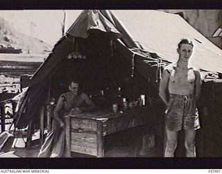 LAE, NEW GUINEA. 1943-10-12. THE COOKHOUSE ABOARD THE PD.240, A 50 TON FLOATING CRANE, OPERATED BY THE UNITED STATES SMALL SHIPS SECTION. SHOWN: C. MCCLAUSLAND (LEFT), AND M. FRENSHAM, COOK