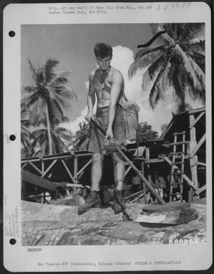 Pvt. Daniel Phillips Of East Los Angeles, California Uses A Mine-Detector On The Logs To Locate Shrapnel Fragments That Are Sometimes Deeply Imbedded Into The Logs. The Detector Will Penetrate And Accurately Designate Foriegn Metals That Are In The Wood (U.S. Air Force Number 68826AC)