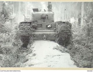 MILILAT, NEW GUINEA. 1944-10-12. 'THE STORK', A CHURCHILL V TANK OF HQ 4 ARMOURED BRIGADE BEING TOWED FROM A BOG