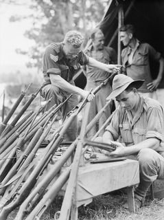 ALEXISHAFEN, NEW GUINEA. 1944-05-11. Q44734 SERGEANT T.K. HANLON (1), AND Q136046 CORPORAL A.J. BOWD (2), MEMBERS OF THE PROVOST CORPS ATTACHED TO THE 8TH INFANTRY BRIGADE, 5TH DIVISION, CLEAN AND ..