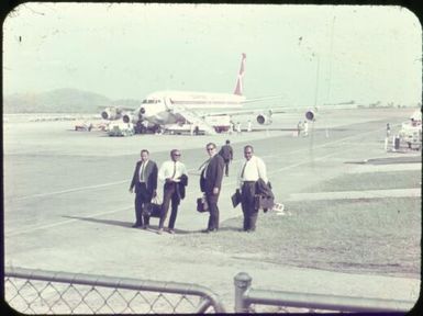 Four doctors on tarmac at Port Moresby, Papua New Guinea, ca. 1951 / Albert Speer