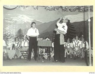 LAE, NEW GUINEA. 1944-08-11. THE MAGICIAN AND HIS ASSISTANT DOING THEIR TURN DURING A CONCERT STAGED FOR PATIENTS OF THE 113TH CONVALESCENT DEPOT BY THE WHITE HORSE INN CONCERT PARTY. THE CONCERT ..