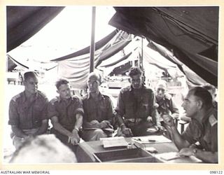 CAPE WOM, NEW GUINEA. 1945-10-20. CORPS OF AUSTRALIAN ELECTRICAL AND MECHANICAL ENGINEERS OFFICERS ATTENDING THE WEEKLY CONFERENCE AT HEADQUARTERS 6 DIVISION. AT THIS CONFERENCE WORK IS REVIEWED, ..