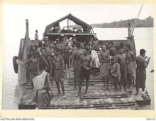 MUSCHU ISLAND, NEW GUINEA. 1945-09-11. MUSCHU ISLAND NATIVES LOADED ON AUSTRALIAN BARGES WAITING TO BE TRANSFERRED TO THE NEW GUINEA MAINLAND, WHERE THEY WILL BE REHABILITATED BY THE AUSTRALIAN NEW ..