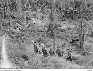 DUMPU, NEW GUINEA. 1944-04-03. MEMBERS OF THE 57/60TH INFANTRY BATTALION MOVING THROUGH THE DISPERSED TENTS AND HAMMOCKS AT B COMPANY HEADQUARTERS NEAR YAULA ON THE MOVE BACK TO DUMPU FOR SUPPLIES. ..