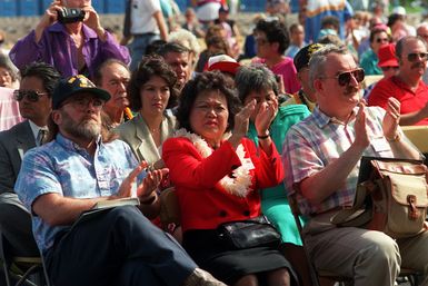 Rep. Patsy Mink and the audience applaud during Remembrance Day ceremonies at the USS ARIZONA Memorial Visitors Center. USS ARIZONA survivors are honored during the commemoration of the 50th anniversary of the Dec. 7, 1941, attack on Pearl Harbor