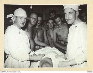 KALAI PLANTATION, HENRY REID BAY, NEW BRITAIN. 1945-03-05. NX70198 MAJOR D. DEL.F. HENRY (1) AND NX34955 MAJOR L.J. CAINS (2) PREPARE TO COMMENCE THEIR FIFTH MAJOR OPERATION FOR THE DAY AT THE 6TH ..