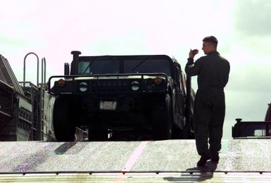 Crewmembers of the Landing Craft, Air Cushioned (LCAC) 57 offloads an M998 High-Mobility Multipurpose Wheeled Vehicle (HMMWV) on the Inner Apra Harbor, Guam, in support of Exercise TANDEM THRUST 2003