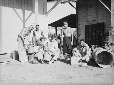 [Six men with canisters]