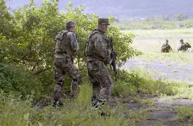 During an exercise, US Air Force (USAF) Airmen from the 25th Assault Special Operations Squadron (ASOS) AIRMAN First Class (A1C) Jesse Wagnon, left and A1C John Dowd move back to the Landing Zone to get their wounded AIRMAN to a secure location and call for an immediate Med-Evac extraction