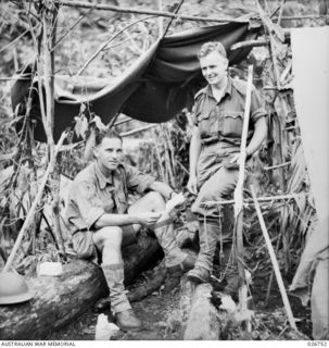 PAPUA, NEW GUINEA, 1942-09. THE COMMANDING OFFICER OF THE 2/16TH AUSTRALIAN INFANTRY BATTALION, LIEUTENANT-COLONEL A. E. CARO, (SITTING), AND CAPTAIN F. H. SUBLET, MC, OFFICER COMMANDING "B" ..