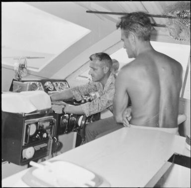 George Beger at the wheel of the boat, Isle of Pines, New Caledonia, 1967 / Michael Terry