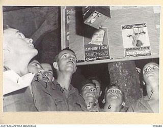 PALMALMAL PLANTATION, JACQUINOT BAY, NEW BRITAIN, 1945-07-03. ANXIOUS PUNTERS ATTENDING THE RACE MEETING OF THE NEW BRITAIN TURF CLUB AT 18 ADVANCED ORDNANCE DEPOT WAIT FOR NUMBERS TO BE SIGNALLED ..