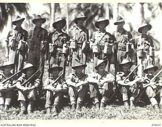 MADANG, NEW GUINEA. 1944-06-30. PERSONNEL OF COMPANY HEADQUARTERS, B COMPANY, 24TH INFANTRY BATTALION. IDENTIFIED PERSONNEL ARE:- VX136262 CORPORAL M.C. OLSEN (1); VX104480 CORPORAL T.J. MITCHELL ..