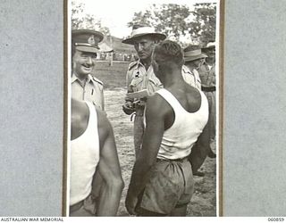 NEW GUINEA. 1943-11-20. NX8 LIEUTENANT GENERAL SIR LESLIE MORSHEAD KCB KBE CMG DSO ED, GENERAL OFFICER COMMANDING, NEW GUINEA FORCE CONGRATULATING WINNERS OF THE VARIOUS EVENTS AT THE CHAMPIONSHIP ..