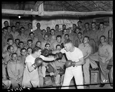 World War II soldiers in New Caledonia watching a boxing match between Tom Heeney and Maurice Donovan