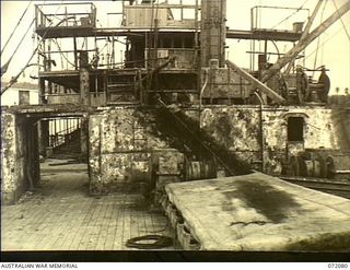 MILNE BAY, NEW GUINEA. 1944-04-05. THE MOTOR VESSEL "ANSHUN", SUNK BY A JAPANESE CRUISER IN MILNE BAY HARBOUR, VIEWED AFTER BEING REFLOATED BY THE COMMONWEALTH SALVAGE MARINE SERVICE USING LABOUR ..