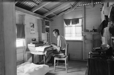 Burland, John Colles, 1926- :J C Burland typing up notes in the Big House, Palmerston Atoll, Cook Islands