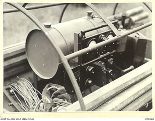 LAE, NEW GUINEA. 1945-01-03. A JEEP TRAILER OF THE 34TH WIRELESS TELEGRAPHY SECTION (HEAVY) LOADED WITH A SMALL 5KVA-240 A, HOWARD MOTOR OF THE MOBILE RADIO STATION OF THE 19TH LINES OF ..