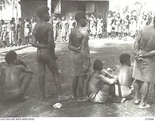 KARKAR ISLAND, NEW GUINEA. 1944-09-19. KANAKA NATIVES FROM HILL VILLAGES, AWAITING ALLOCATION BY MEMBERS OF THE AUSTRALIAN NEW GUINEA ADMINISTRATIVE UNIT TO WORK AT PLANTATIONS ON THE ISLAND