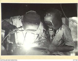 LAE, NEW GUINEA, 1944-03-26. AMERICAN SERVICEMEN WELDING AT THE 267TH UNITED STATES ANTI-AIRCRAFT ORDNANCE MAINTENANCE COMPANY