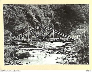 DUMPU AREA, NEW GUINEA. 1944-04-18. MEMBERS OF THE 15TH FIELD COMPANY, ROYAL AUSTRALIAN ENGINEERS IN A JEEP CROSSING THE 60 FOOT SPAN OF A TRUSSED BRIDGE ACROSS THE FARIA RIVER