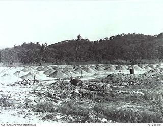 WARDS STRIP, PORT MORESBY, NEW GUINEA, 1943-03. LOADS OF EARTH FILL DUMPED WAITING TO BE LEVELLED OUT BY NO. 2 AND NO. 5 MOBILE WORKS SQUADRON (LATER AIRFIELD CONSTRUCTION SQUADRON). ORIGINAL PRINT ..