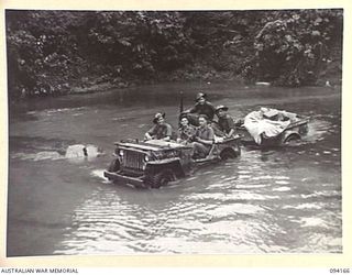 BOUGAINVILLE. 1945-07-18. A JEEP AND TRAILER LOADED WITH ENGINEERS OF 15 FIELD COMPANY, ROYAL AUSTRALIAN ENGINEERS, AND STORES, FORDING THE OGORATA RIVER. THE ENGINEERS FOLLOW IN THE WAKE OF THE ..