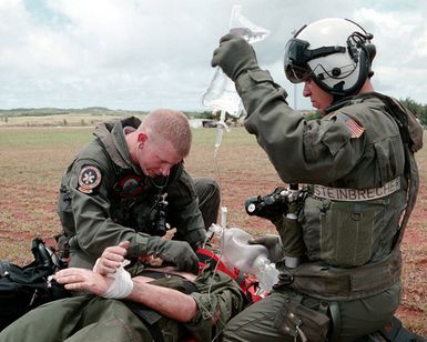 Hospital Corpsman Third Class (HM3) Raymond Munn, Helicopter Combat Support Squadron Five (HCSS5), from Cheyenne, Wyoming (left) and Aviation Machinist's Mate Third Class (AD3) Todd Steinbrecher, from Kansas City, Kansas, listen for the correct tube placement on a intubeated trauma victim during an overland Search And Rescue (SAR) training exercise