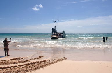 A US Navy (USN) Sailor (left) from Beachmaster Unit 1(BMU-1) offloads a Logistical Amphibious Recovery Craft (LARC) from a Landing Craft Utility (LCU) at a beach at Bellows Air Force Station (AFS), Hawaii (HI), during an amphibious assault training during Exercise Rim of the Pacific (RIMPAC) 2006. The exercise designed to increase the tactical proficiency of participating units in a wide array of combined sea operations. RIMPAC 2006 brings together military forces from Australia (AUS), Canada (CAN), Chile (CHL), Peru (PER), Japan (JPN), the Republic of Korea (KOR), United Kingdom (UK) and the United States (US)