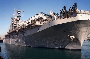 A close up view of the starboard bow of the TARAWA CLASS AMPHIBIOUS ASSAULT SHIP USS SAIPAN (LHA 2) as it gets a tow entering the harbor at Naval Station Rota, Spain. The SAIPANS crew will assist in wash-down and inspection of all land vehicles onboard ship during the port visit