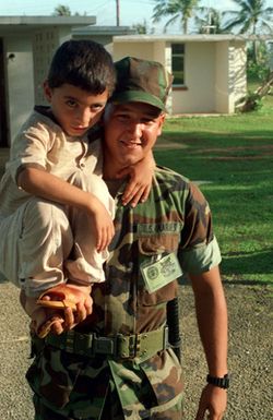 Lance CPL. S. L. Cooper, Bravo Company, 1ST Battalion, 3rd Marines, 2nd Marine Division plays with a young Kurdish boy during his interior patrol. Infantrymen assist the military police by providing interior and exterior security