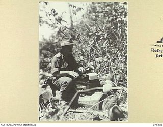 MILILAT, NEW GUINEA. 1944-08-13. NX15943 LIEUTENANT J.S. CLEARY, MILITARY HISTORY SECTION TYPING HIS DESPATCH TO BE SENT BACK TO THE MAINLAND