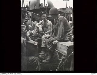 AT SEA IN THE ADMIRALTY ISLANDS AREA. 1944-03-08. RAAF AIRMEN AND AMERICAN TROOPS ON BOARD SHIP ON THE WAY TO REINFORCE THE ADMIRALTY ISLANDS