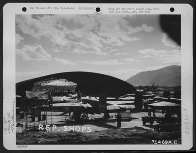 North American B-25S, Parked Outside The Hangar Of The 13Th Air Depot Group On New Caledonia, Are Awaiting Repair Work. (U.S. Air Force Number 71469AC)