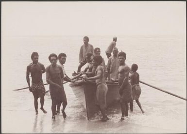 Men with boat on a beach at the village of Dorig, Santa Maria, Banks Islands, 1906 / J.W. Beattie