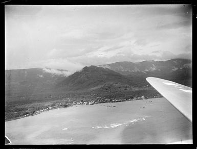 Apia Harbour and coastal settlement with forest covered mountains beyond, Western Samoa