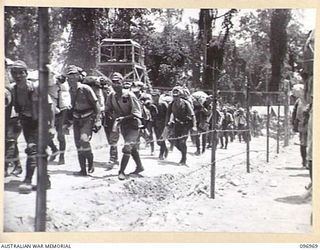 TOROKINA, BOUGAINVILLE. 1945-09-23. JAPANESE NAVAL TROOPS WHO HAVE JUST FINISHED A 10-MILE MARCH FROM THE BUKA AREA, ESCORTED BY TROOPS OF 27 INFANTRY BATTALION, MARCHING ALONG A ROAD IN THE ..