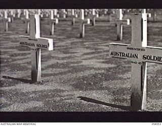 SOPUTA, NEW GUINEA, 1943-07-20. WOODEN CROSSES MARKING THE GRAVES OF UNIDENTIFIED AUSTRALIAN SOLDIERS AT THE SOPUTA WAR CEMETERY