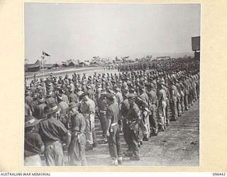 CAPE WOM, NEW GUINEA, 1945-09-13. TROOPS OF 6 DIVISION LINING UP FOR THE SURRENDER CEREMONY HELD AT CAPE WOM AIRSTRIP WHERE LIEUTENANT-GENERAL H. ADACHI, COMMANDER 18 JAPANESE ARMY IN NEW GUINEA ..