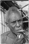 An elderly Kwaio man shaves by pulling out his whiskers with a clam shell