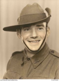 Hand coloured studio portrait of QX15599 Private (Pte) Raymond Timothy Buckley, 2/9 Battalion. Pte Buckley enlisted at Malanda, Qld, on 14 May 1941, served in the Middle East and was killed in ..