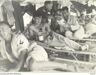 NAGADA, NEW GUINEA. 1944-09-21. DX55 SERGEANT S.J. SAGE, AUSTRALIAN RED CROSS SOCIETY ATTACHED TO THE 11TH FIELD AMBULANCE (2), HANDING SOFT DRINKS TO PATIENTS. IDENTIFIED PERSONNEL ARE:- NX156178 ..