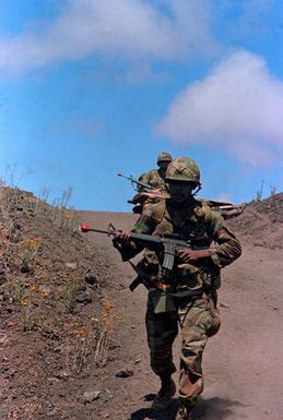 Members of the 2nd Brigade of the 25th Infantry Division move toward their objective during training exercises at the US Army's Pohakuloa Training Area. The 25th Infantry Division is preparing for Team Spirit '84, a joint South Korean/US training exercise held annually in Korea