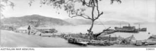 Port Moresby, Papua. 1942-08. A view from the township area looking across the harbour and surrounding hills with an anti aircraft crew and gun in the foreground