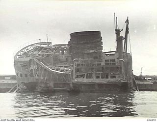 1943-05-19. NEW GUINEA. GONA. THIS WRECKED JAPANESE SHIP "AYATOSAN MARU", SUNK BY ALLIED AIRCRAFT DURING THE BATTLE FOR GONA. IT IS NOW USED FOR TARGET PRACTICE BY ALLIED FORCES AT GONA BEACH. ..