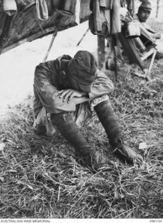 MUSCHU ISLAND, NEW GUINEA. 1945-09-11. A JAPANESE SOLDIER WITH HIS HEAD ON HIS KNEES, LOOKING DEJECTED. THE AREA IS NOW OCCUPIED BY HEADQUARTERS 6 DIVISION. THE ISLAND WAS SURRENDERED BY ..