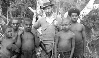 A.J. Bearup with young boys from the Mogei area, Mount Hagen, collecting Anopheles mosquito larvae, 1934 / [G. Heydon]