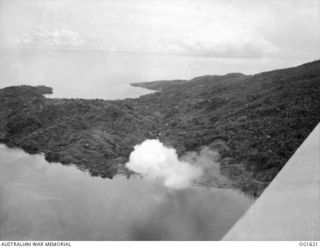 WEWAK AREA, NORTH EAST NEW GUINEA. C. 1944-10. AERIAL VIEW OF SMOKE BILLOWING FROM COASTLINE TARGETS IN THE WEWAK AREA SET ON FIRE IN AN AIR ATTACK BY AIRCRAFT OF NO. 8 (BEAUFORT) SQUADRON RAAF